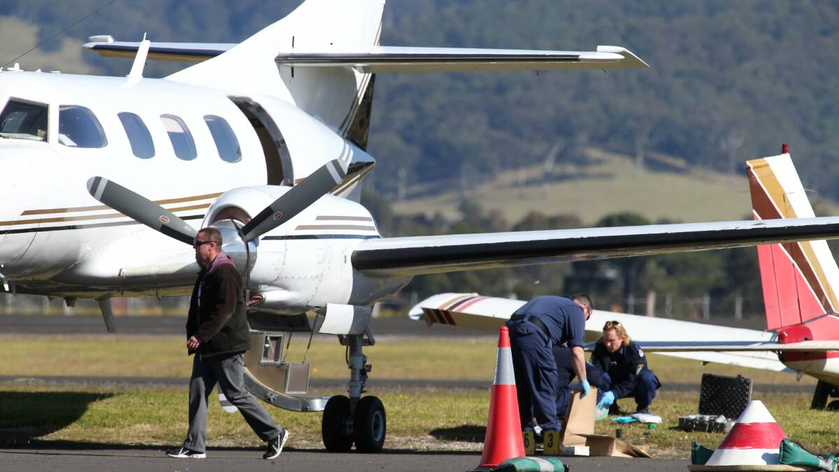 Police raid a plane at Illawarra Regional Airport on Wednesday. Picture: KIRK GILMOUR