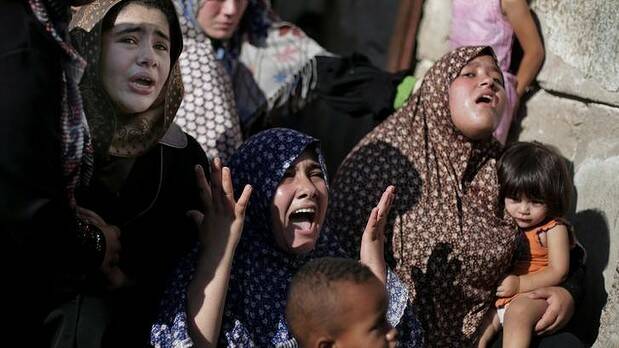 Palestinian relatives of four boys from the same extended Bakr family, grieve during their funeral in Gaza City. Photo: AP