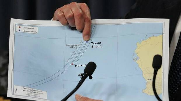 Retired Air Chief Marshal Angus Houston points to a graphic of the search area for the missing jet. Picture: AFP