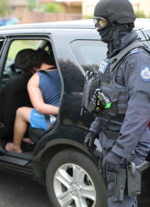 A male is arrested during Operation Appleby raids in Sydney's south-west on Thursday. Photo: NSW Police
