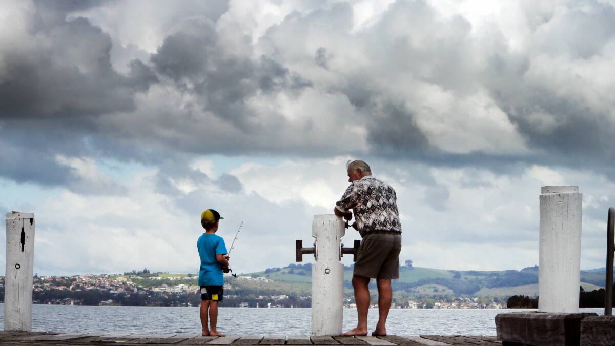 Photographer Kirk Gilmour captures clouds as they gather over the coastline at Lake Illawarra. 