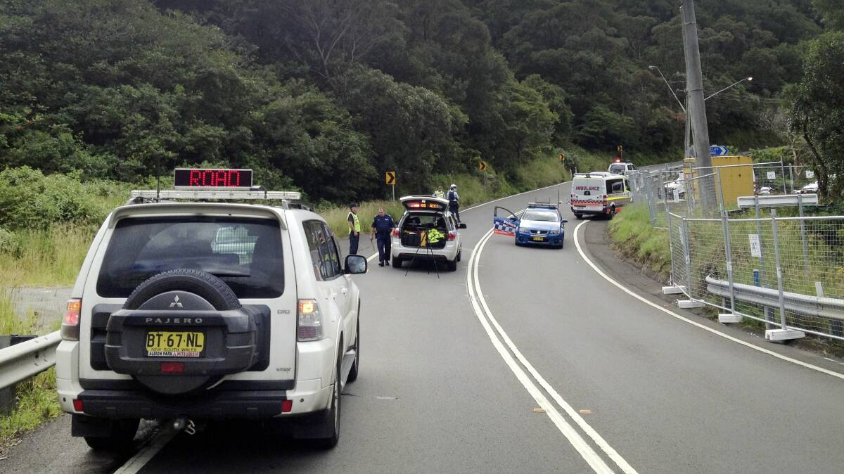 Police set up a road block after a cyclist was hit in Coalcliff on Friday. Picture: ADAM McLEAN