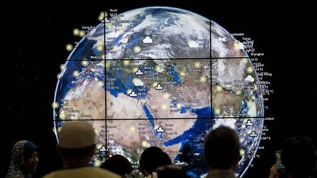 People look at a ''digital Earth'' displayed at Kuala Lumpur International Airport. Picture: AFP