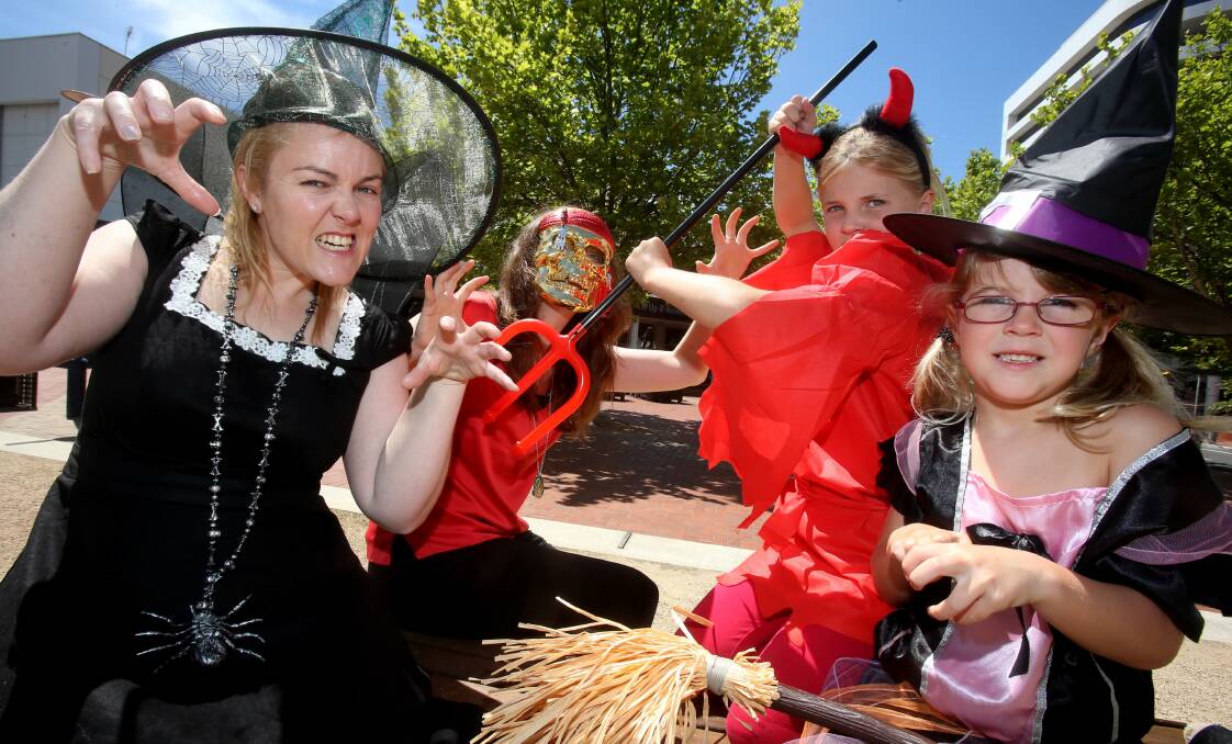 Wollongong Council's Robyn and Bronwyn join East Corrimal sisters Taylor, 7, and Piper Crutchley, 5, in getting into the Halloween spirit ahead of Saturday’s Moonlight Movies screening of Hotel Transylvania. Picture: ROBERT PEET