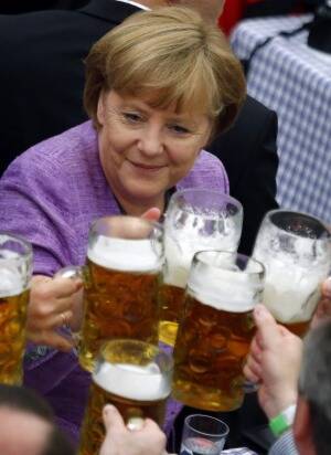 Handling it: Angela Merkel raises a glass at a traditional folk festival in southern Germany in 2012. Piciture: REUTERS