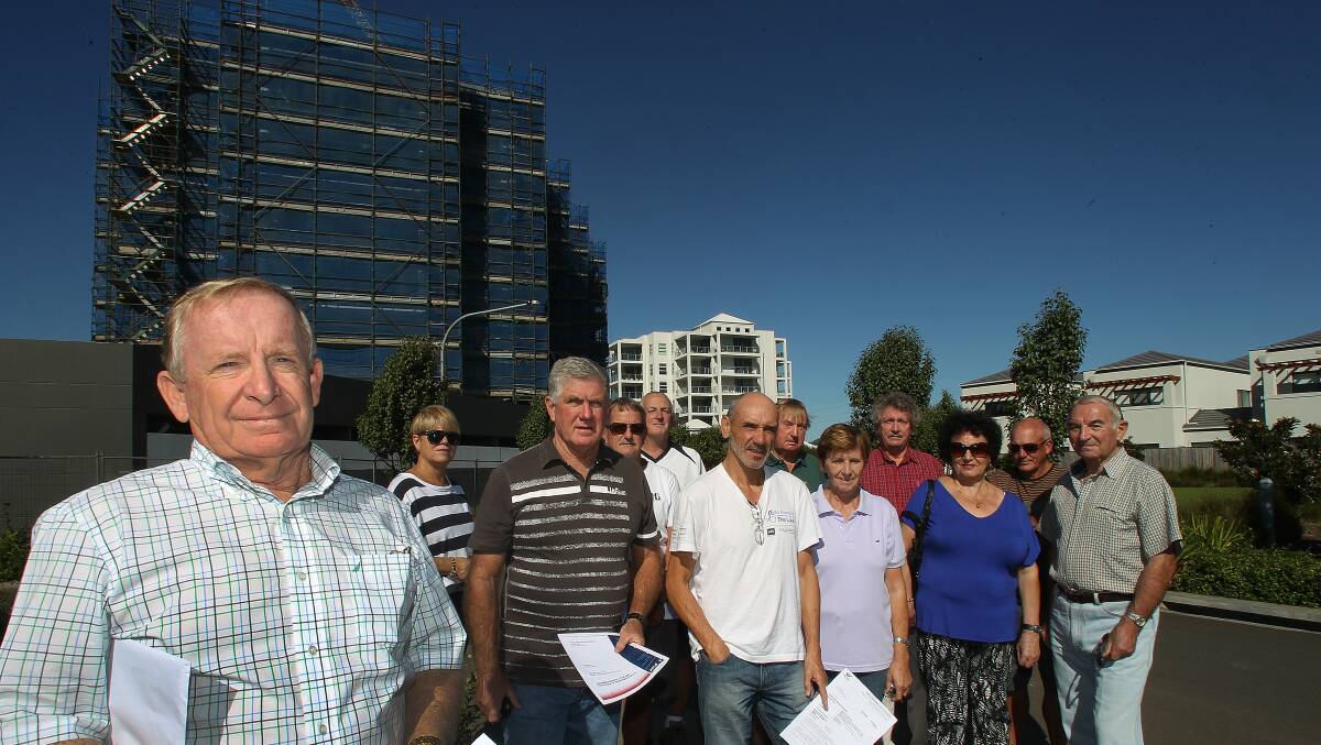 Traffic  fears: Ian Birch, front, and other residents are angry about development plans for a new apartment tower which will double the number of flats in an approved seven-storey Fairy Meadow complex. They say the plan will dramatically change their street.  Picture: GREG TOTMAN