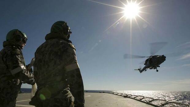 A helicopter leaves the flight deck of HMAS Success as it searches for the missing plane. Picture: AFP