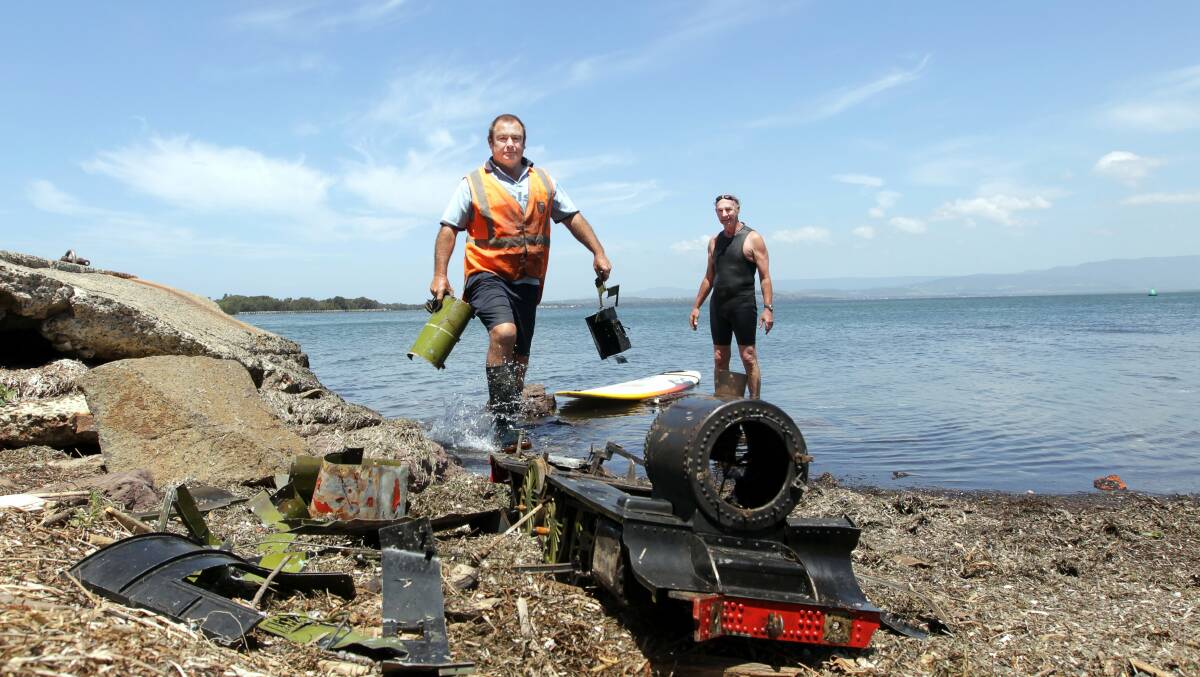 Chris Wilson and Denis McAllister retrieving parts of the stolen train. Picture: SYLVIA LIBER