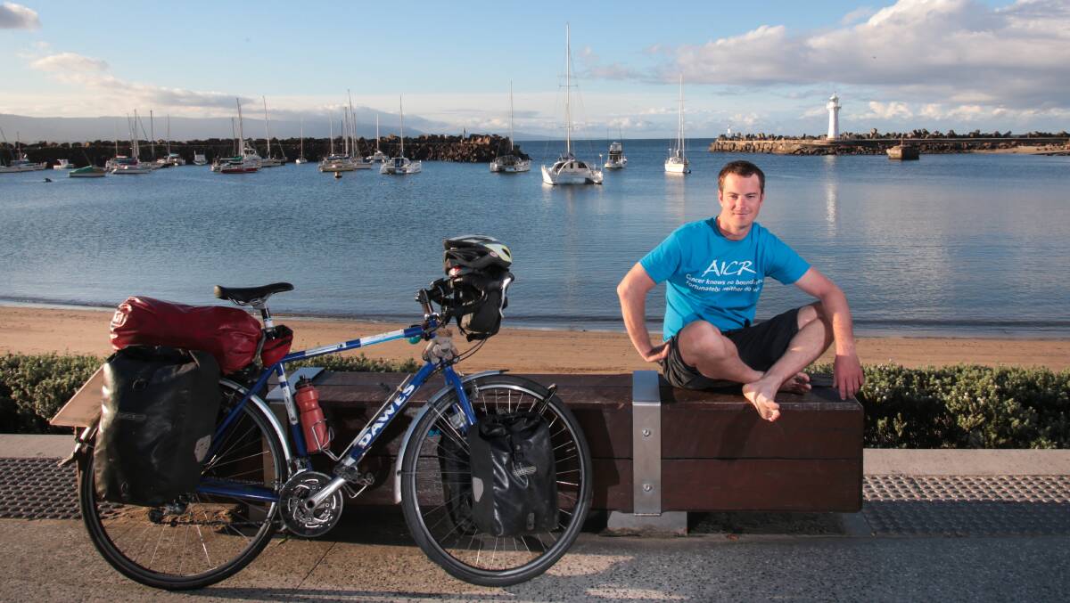 Chris Gruar during a stopover for fish and chips in Wollongong at the tail-end of a 45,000-kilometre cycle across the globe. Picture: ADAM McLEAN
