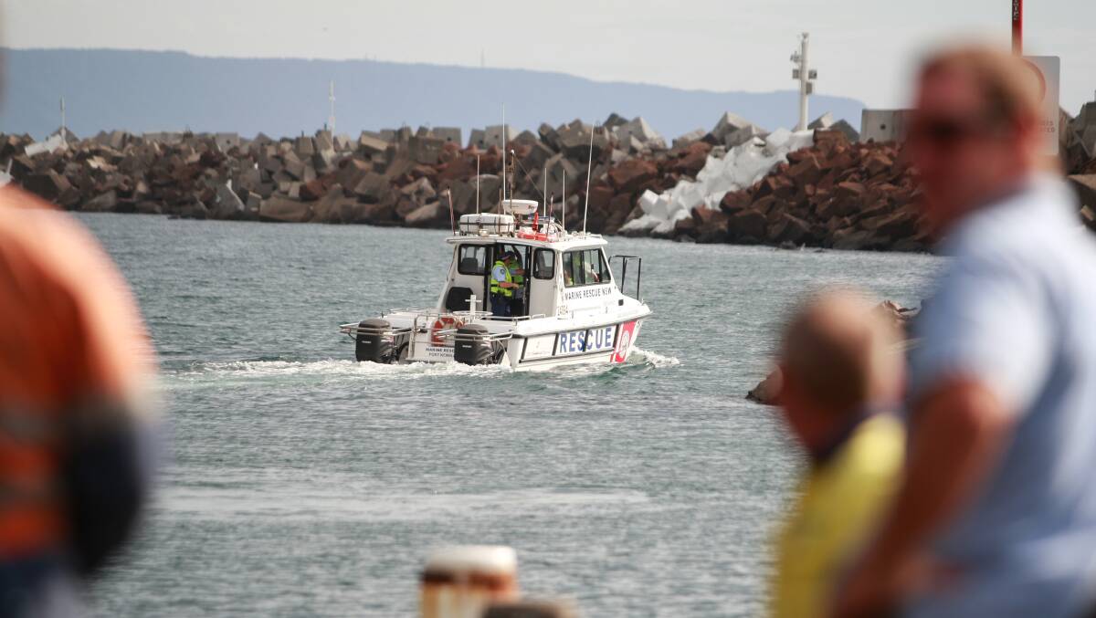 Three men were rescued after boat capsized near Port Kembla on Friday. Picture: CHRISTOPHER CHAN