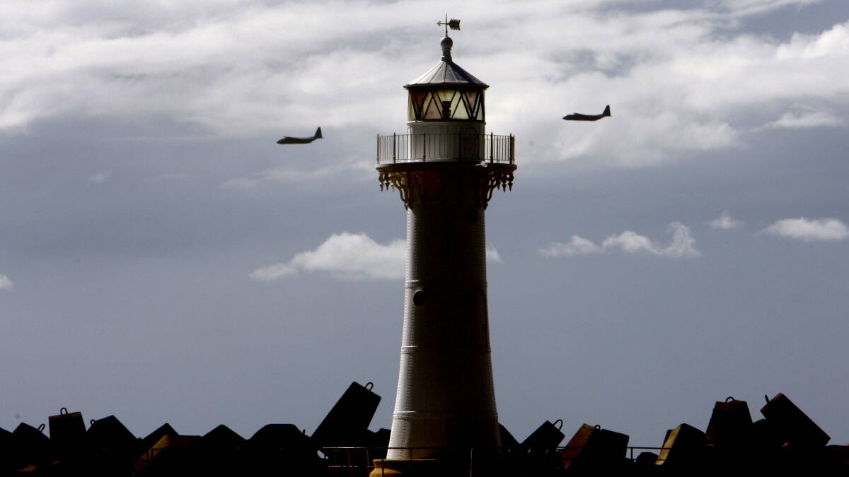 RAAF aircrafts conduct a tactical flying formation in Wollongong on Thursday. Picture: ANDY ZAKELI