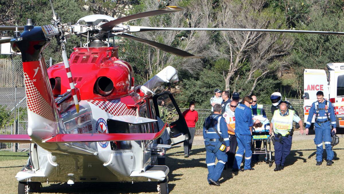 Emergency services prepare to airlift the woman. Photo: KIRK GILMOUR