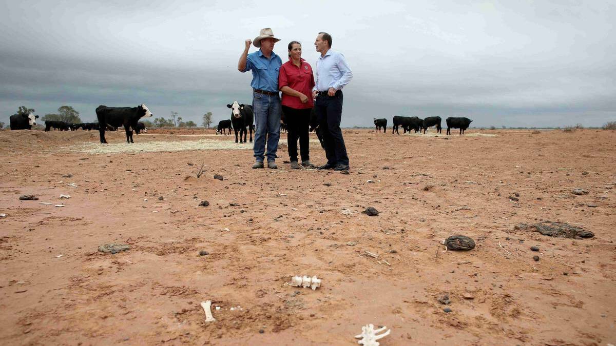 Prime Minister Tony Abbott meets graziers Phillip and Di Ridge of 'Jandra' as part of a drought tour near Bourke. Picture: Getty Images