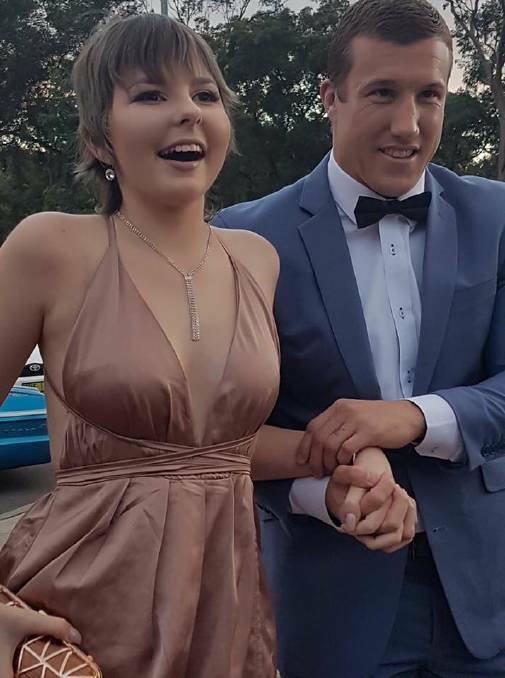 Newcastle Knights player Trent Hodkinson with Hannah Rye on the way to the formal.