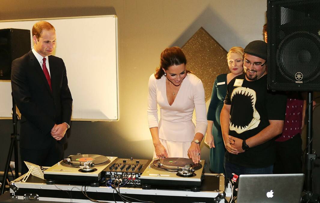 Catherine, Duchess of Cambridge gestures after she used the DJ decks at the youth community centre. Picture: REUTERS