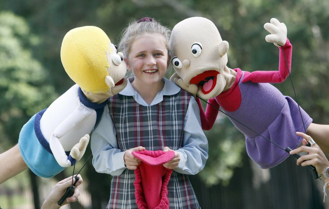 Mt St Thomas student Sophie Barnhill meets Kylie the puppet controlled by Alice Keohavong and puppet Dean controlled by Tim Dal Cortivo. Picture: ANDY ZAKELI