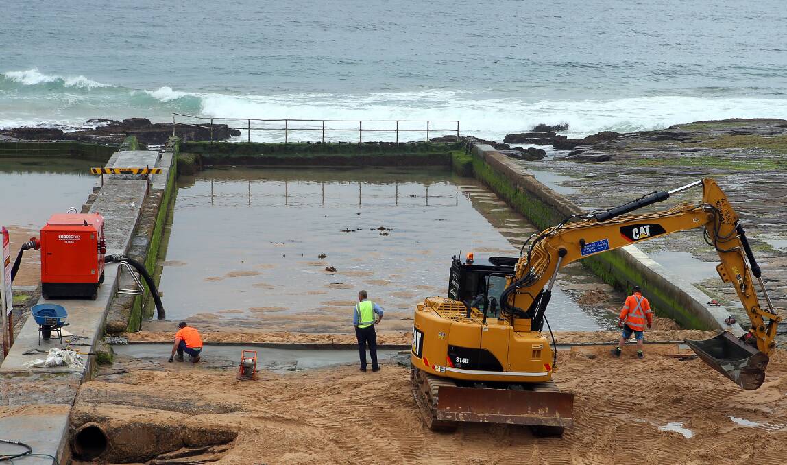 New contractors working on Austinmer's troubled ocean pool. Work was to have been completed in October. Picture: KIRK GILMOUR