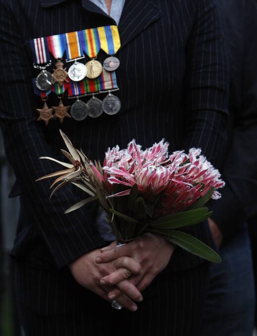 Lynette Robb of Batemans Bay wears her father's medals. Picture: ANDY ZAKELI