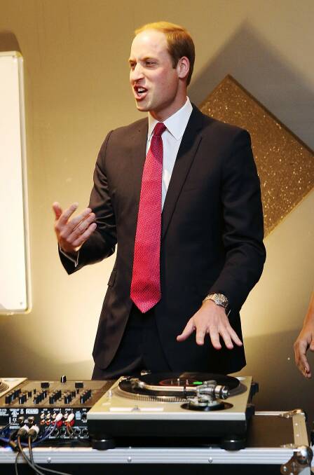 Prince William, Duke of Cambridge is shown how to play on DJ decks at the youth community centre. Picture : REUTERS