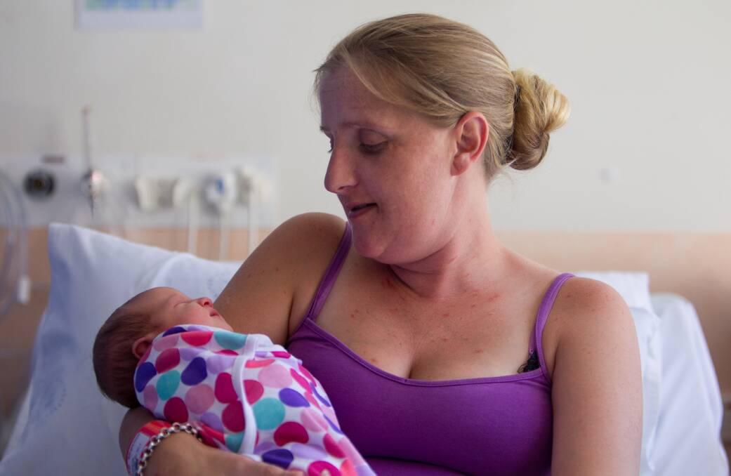 Baby Brooklyn gets cosy with  mum Rachel Shaw  after her Christmas morning birth. Picture: CHRISTOPHER CHAN