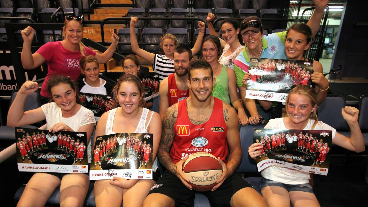 Hawks players Larry Davidson and Tyson Demos (front) signed autographs for students and teachers from West Wyalong High School at WIN Entertainment Centre on Thursday.  Picture: KIRK GILMOUR