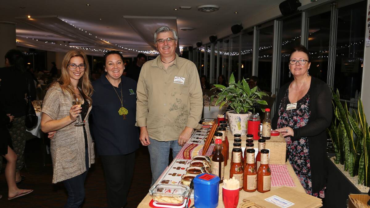 Jonni Nicolaou with Marie Smith, of Early Years Care, and Portors Produce stallholders Craig Roy and Trish Roy at the Lagoon Seafood Restaurant night markets. Picture: GREG ELLIS