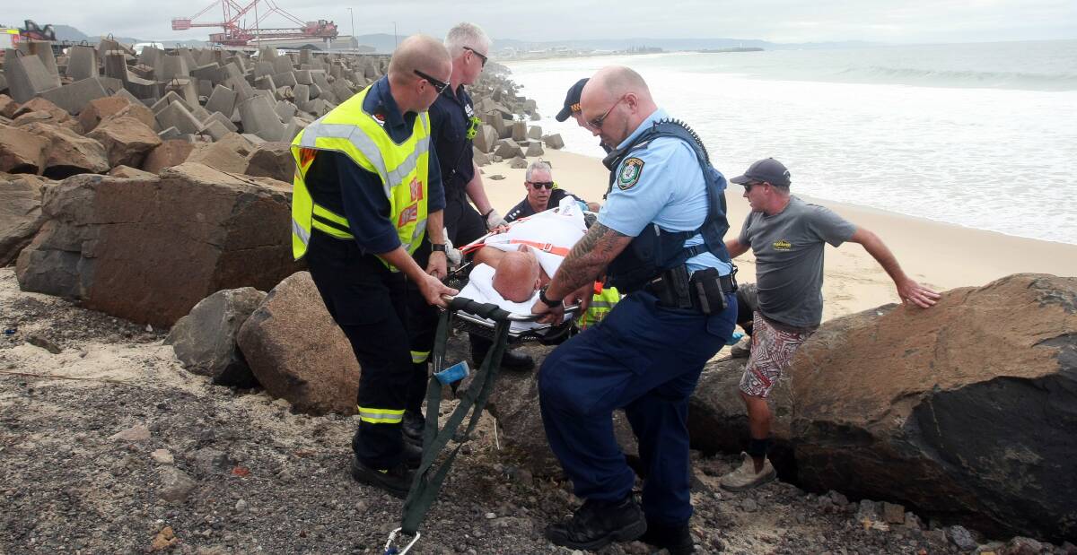 Rescuers start lifting the injured surfer towards a waiting ambulance. Pictures: SYLVIA LIBER