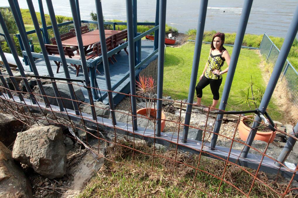  Samantha Douglas with her  damaged fence after the attack. Picture: SYLVIA LIBER