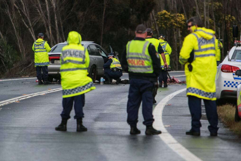 Police at the scene of Friday's crash that claimed two lives. Picture: CHRISTOPHER CHAN.