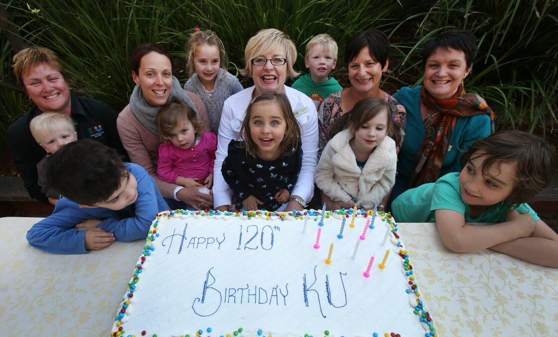 Fiona Harris, centre, and other KU Wombarra  Preschool educators  celebrate with some of the  preschool children. Picture:  KIRK GILMOUR
