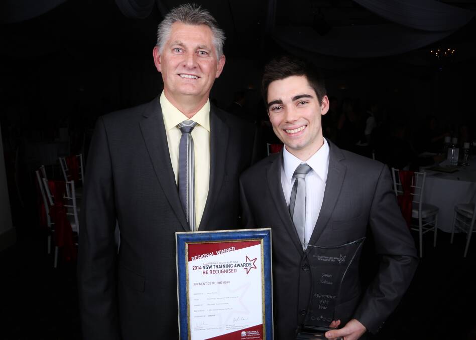 Leussink Engineering training supervisor Allan Van Elsland congratulates James Totman after he was named Apprentice of the Year at the Vocational Training Committee  Illawarra and South East NSW Region Training Awards. Picture: GREG ELLIS
