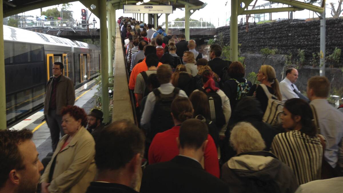 Commuters face a squeeze at Waterfall train station, waiting for buses that replace trains.