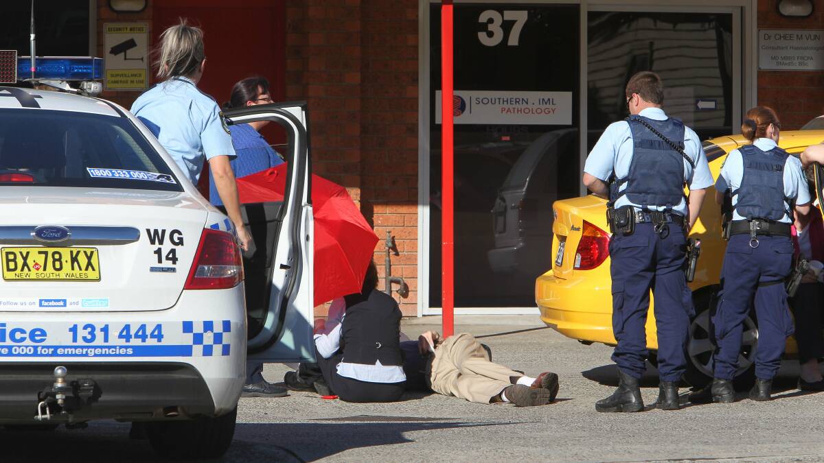 An elderly man is attended to after being hit by a car in Denison St. Picture: KIRK GILMOUR