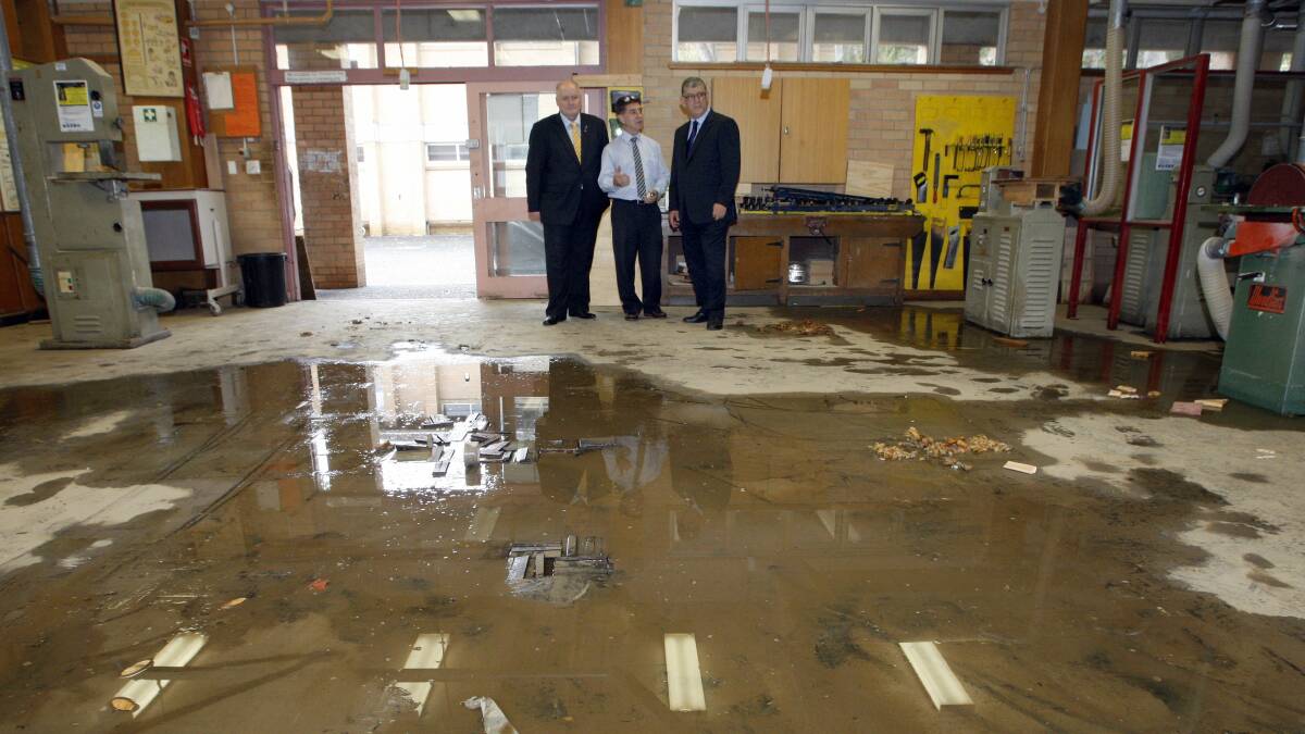 Heathcote MP Lee Evans, school principal Lou Tome and Minister for the Illawarra  John Ajaka at the scene of the flooding at Bulli High School. Picture: ANDY ZAKELI