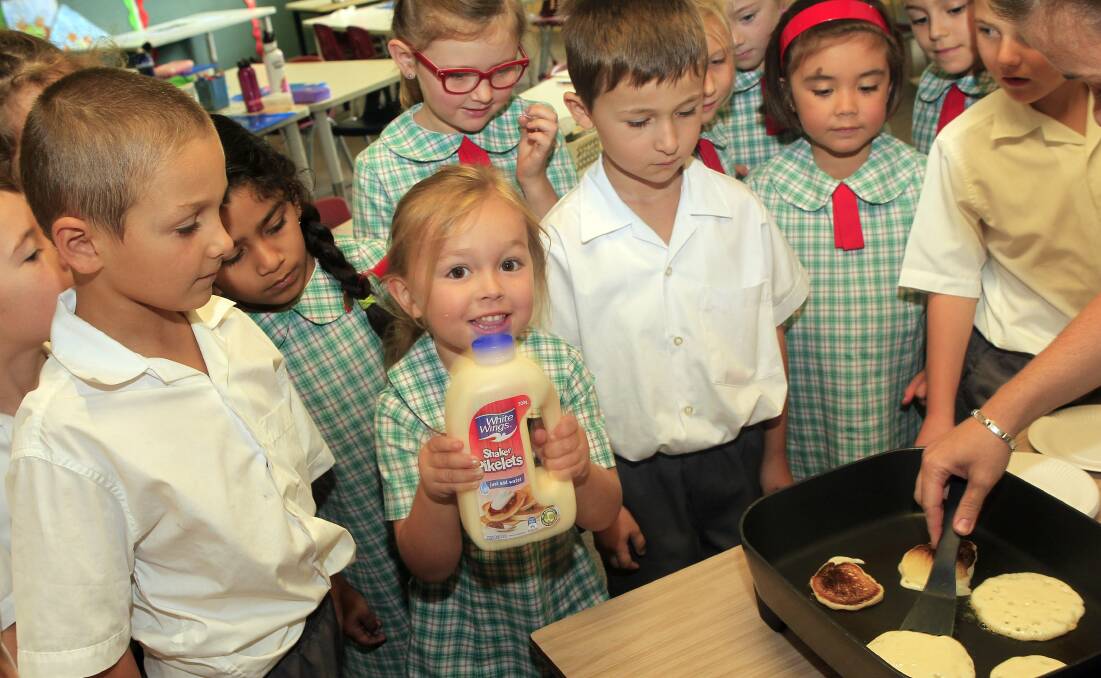 St Brigid's students gather around for the pancakes. Picture: ANDY ZAKELI