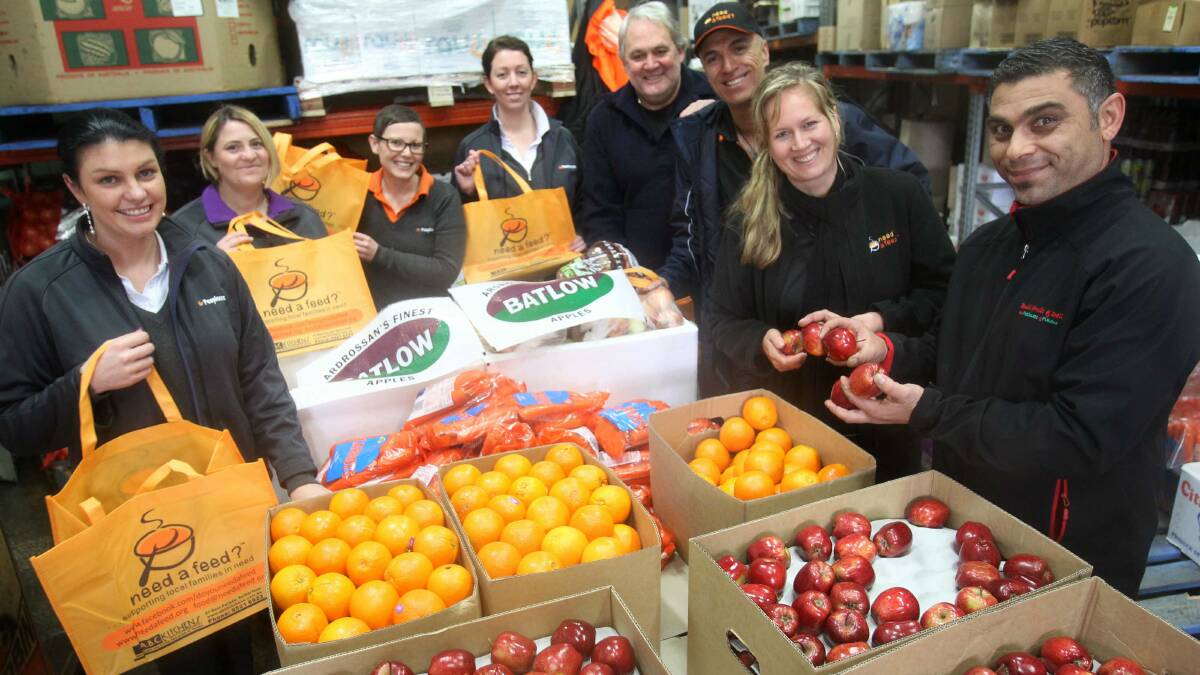 Need a van: Need a Feed co-ordinator Shaz Harrison-Shaw and Gary Mustafa (right) from Bulli Fruit and Deli with people from Access Community Group.  Picture: GREG TOTMAN