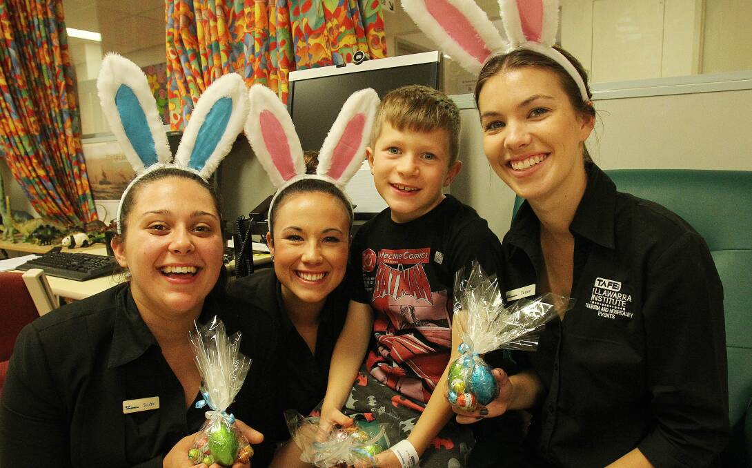 TAFE students Sophie Aroutsidis, Amy Middleton, and Tatum Zotti brought some Easter cheer to sick kids at Wollongong Hospital Children's Ward including Jackson Ritchie age 7. Picture: GREG TOTMAN