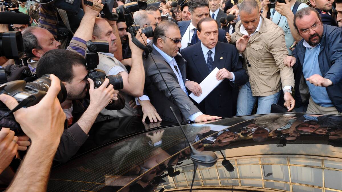 A disgraced Silvio Berlusconi besieged by media in 2014.
Picture: GETTY IMAGES