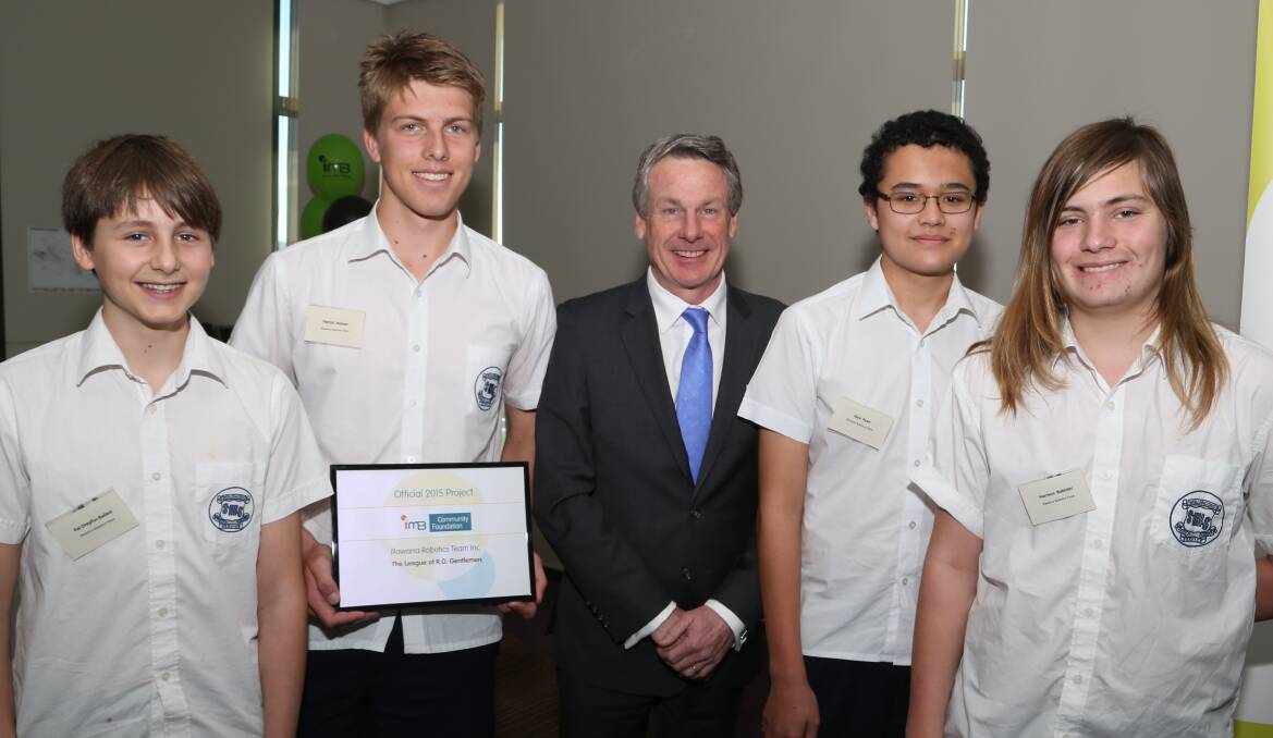 IMB chief executive Robert Ryan (centre) with Smith's Hill High School  Yr 10 students Kai Dreyfu-Ballesi, Patrick Hutton, Jaya Ryan and Harrison Babister who received funding for their Illawarra Robotics Team project at the IMB Community Foundation funding presentation. Picture: GREG ELLIS.