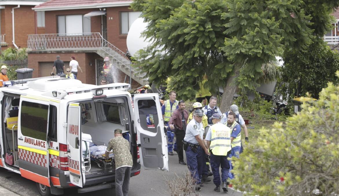 Emergency services at the scene of a Unanderra house that a garbage truck crashed into on Monday. Picture: ANDY ZAKELI