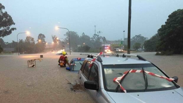A car under water during severe weather in SEQ on Friday. Picture: Queensland Fire and Emergency Service.
