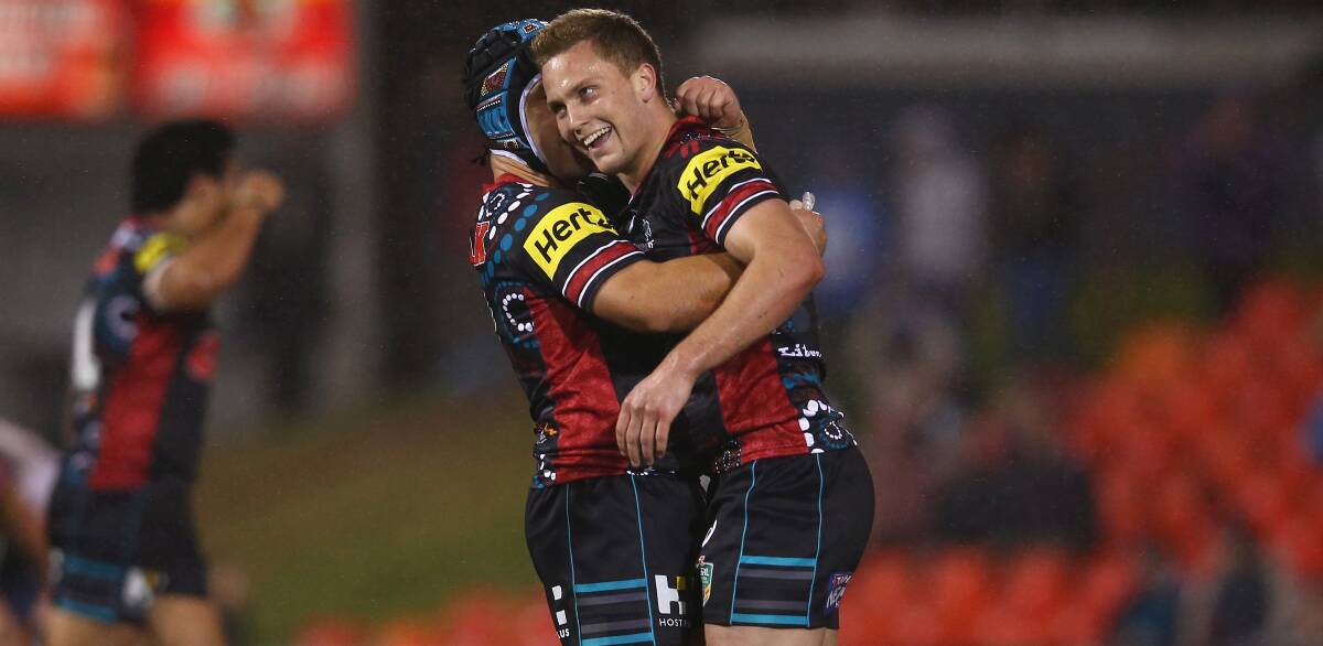 Penrith fullback Matt Moylan is hugged by Jamie Soward at fulltime. Moylan kicked a match-winning field goal against North Queensland on Monday night. Picture: GETTY IMAGES