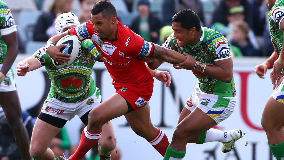 Dragons half Benji Marshall attempts to slip from Anthony Milford's grasp in Saturday's match in Canberra. Picture: GETTY IMAGES