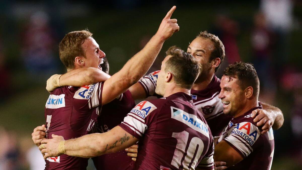 Daly Cherry-Evans, left, celebrates with his Manly team-mates after kicking the winning field goal against Newcastle on Monday night. Picture: GETTY IMAGES