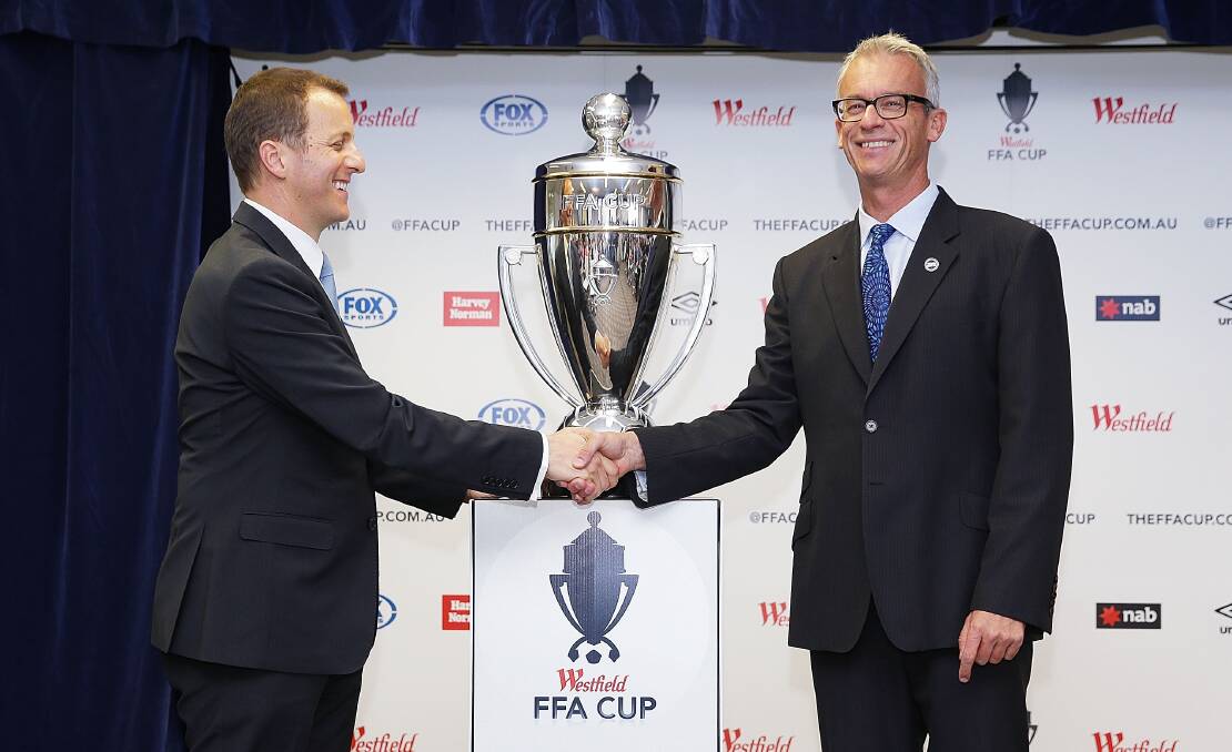 David Gallop (right) shakes hands with Westfield Australia's Director of Marketing, John Batistich, during the FFA Cup sponsorship announcement on Monday. Picture: GETTY IMAGES