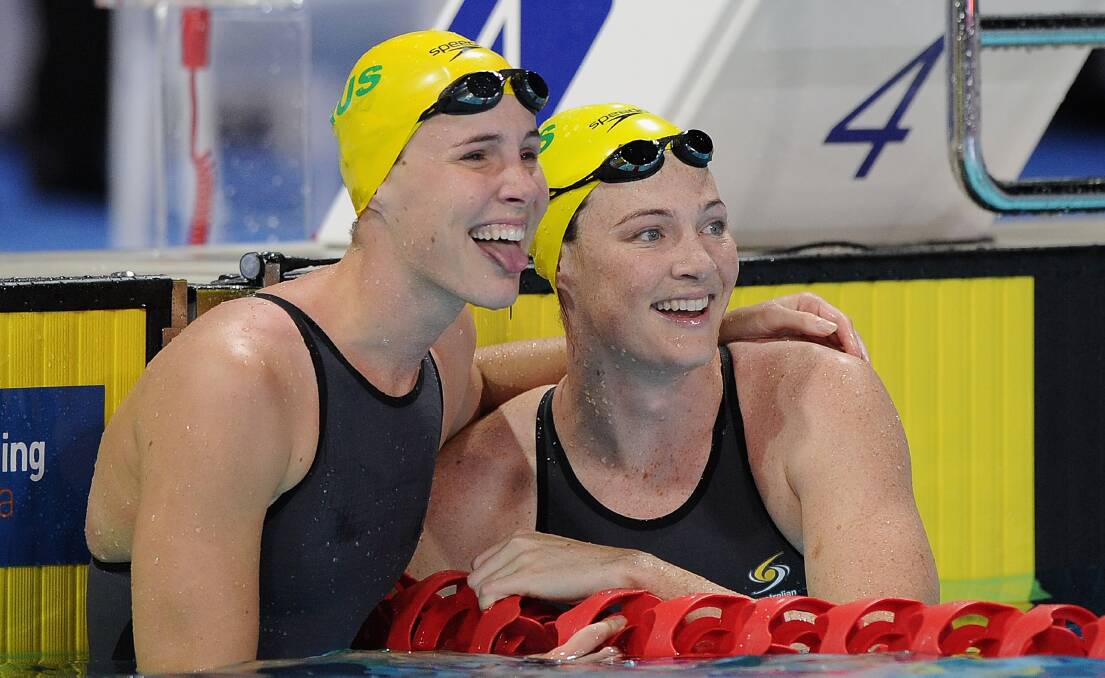 Cate Campbell (right) celebrates winning the women's 50m freestyle final with sister Bronte Campbell at the 2014 Pan Pacific Championships at Gold Coast Aquatics on Sunday. Picture: GETTY IMAGES