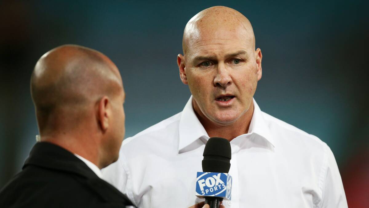 Dragons coach Paul McGregor conducts an interview before Monday's match against the Rabbitohs. Picture: GETTY IMAGES

