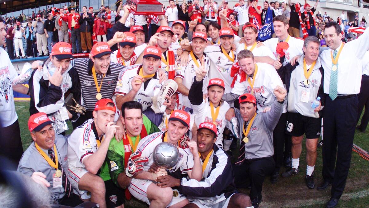 The Wollongong Wolves celebrate their grand final win over Perth Glory in 2000. Picture: KIRK GILMOUR