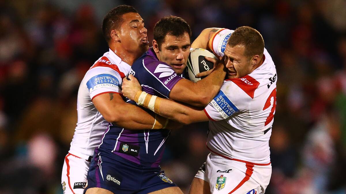 Dragons forwards Bronson Harrison and Trent Merrin wrap up Melbourne's Cameron Smith on Monday night. Picture: GETTY IMAGES.