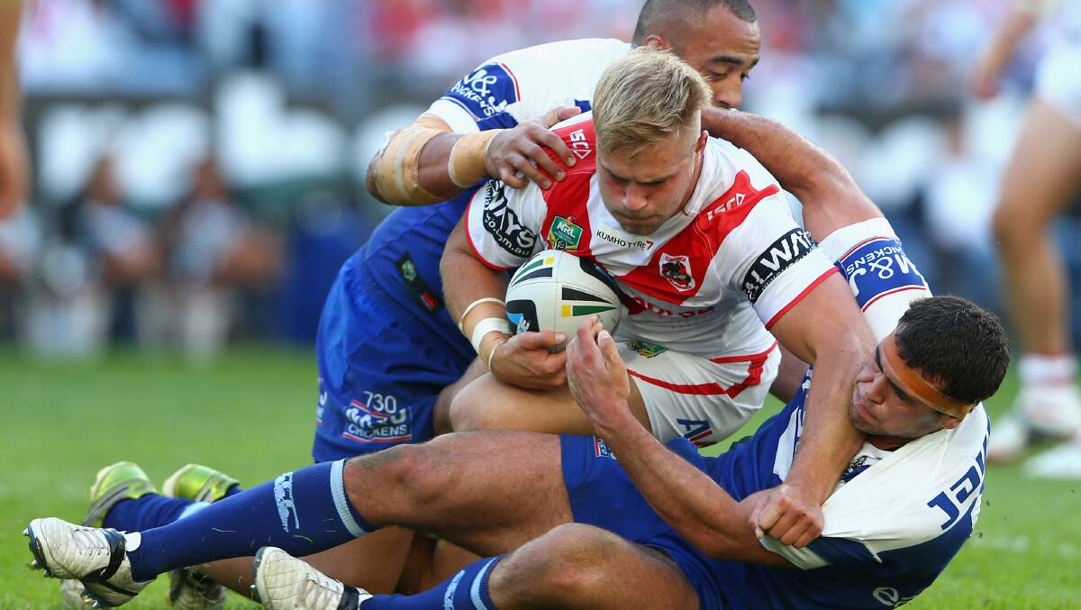 Dragons prop Jack de Bellin is dragged to the ground in Sunday's loss to the Bulldogs at ANZ Stadium. Picture: GETTY IMAGES